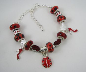 Silver bracelet with red ladybug beads