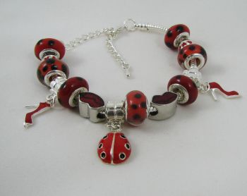 Silver bracelet with red ladybug beads