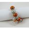 Silver bracelet with orange beads and knot