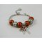 Silver bracelet with orange beads and knot