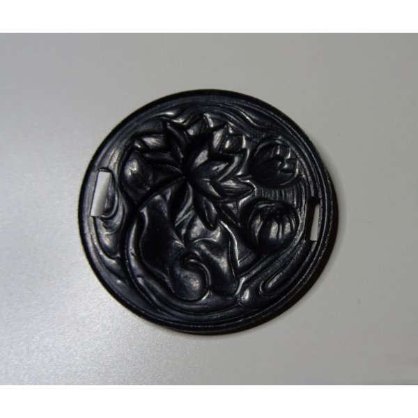 Water lily medallion in black metal relief with side ties 