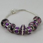 Silver bracelet with purple pearls and rhinestones